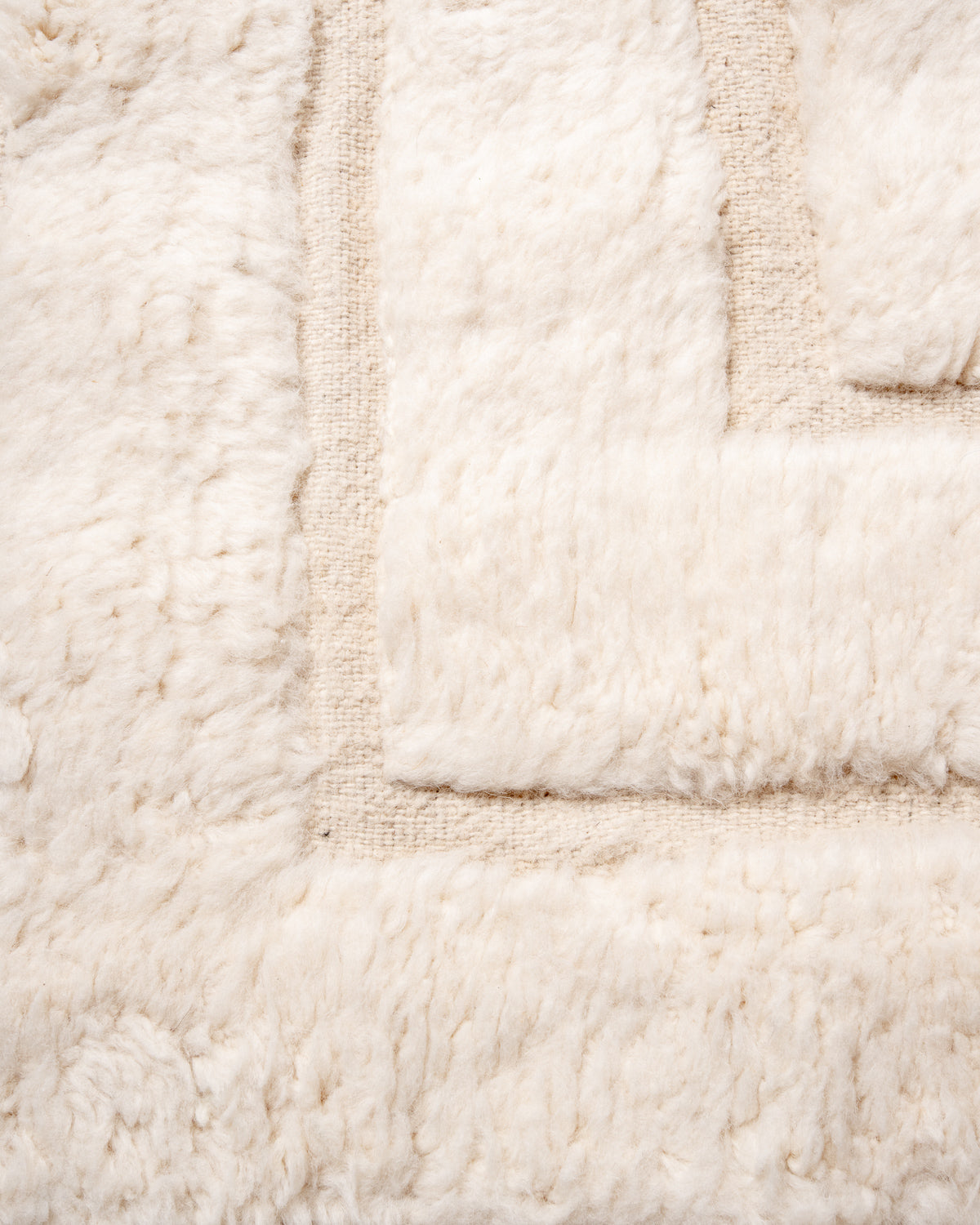 Modern, designer, handcrafted Berber rug from Morocco. Beniourain carpet with minimalist design, natural wool pile and a fluffy texture